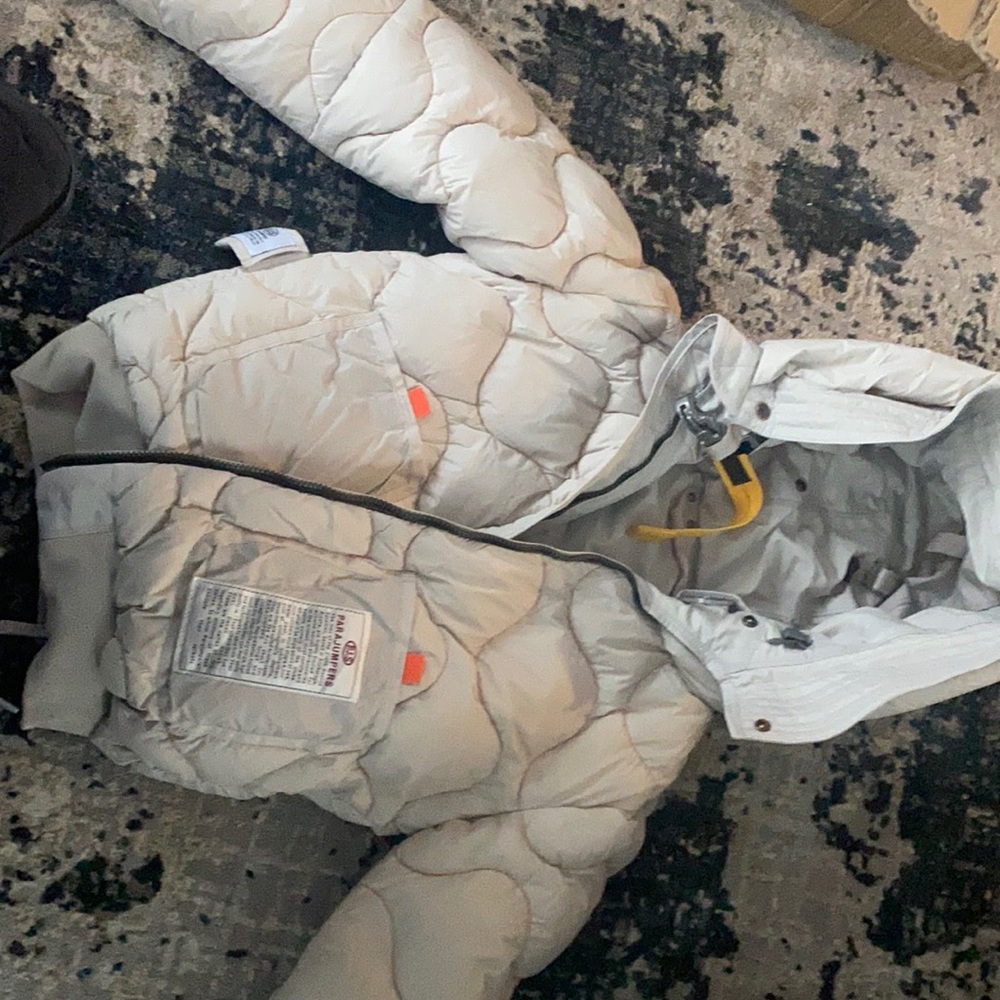 This is a cream color puff jacket size small.